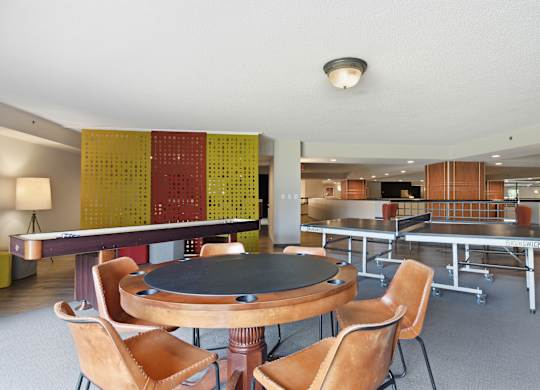 A dining room with a round table and chairs.