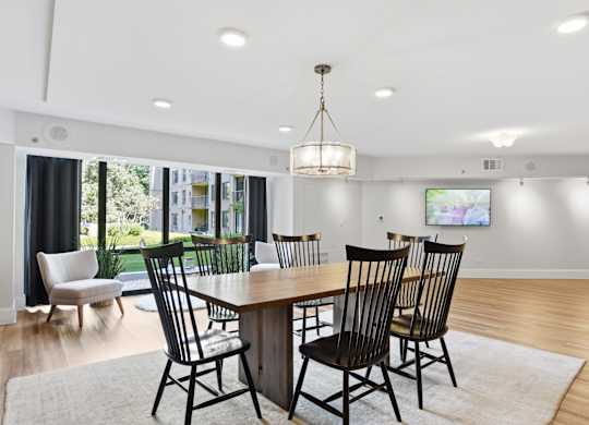 A dining room with a wooden table and chairs.