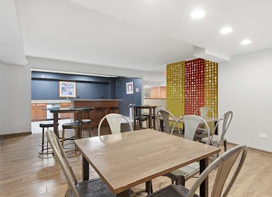 A dining room with a wooden table and chairs.