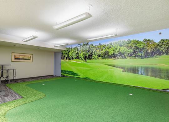 A room with a golf course mural on the wall.