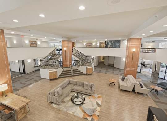 A large open space with a staircase and seating area.