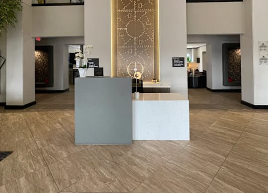 A reception area with a large golden door and a grey reception desk.