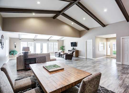 A large, modern dining room with a wooden table and chairs.