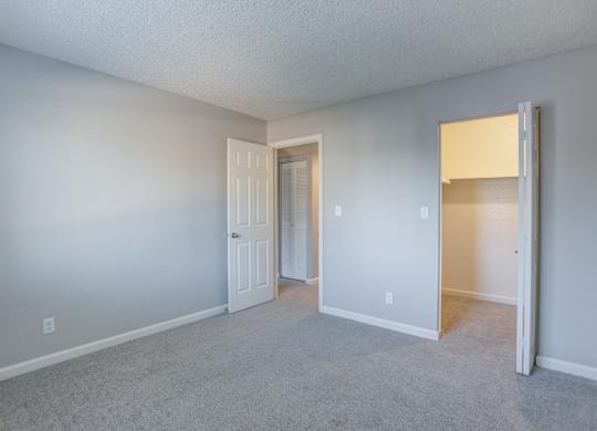 A room with a carpeted floor and white walls.