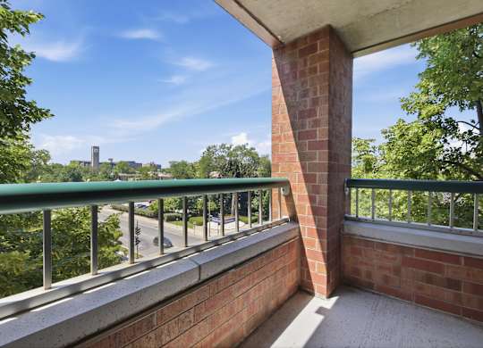 A corner balcony with a metal railing and view of Northwestern University.