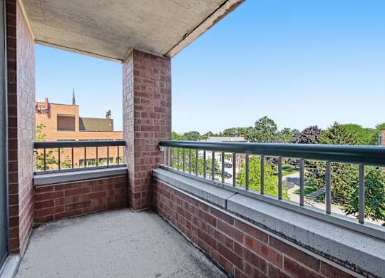A corner balcony with a metal railing and view of Northwestern University.