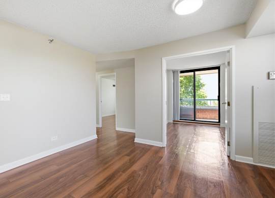 A living room looking into an attached den with private baloncy.