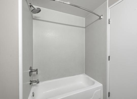 A modern renovated bathroom with a tub shower combo.