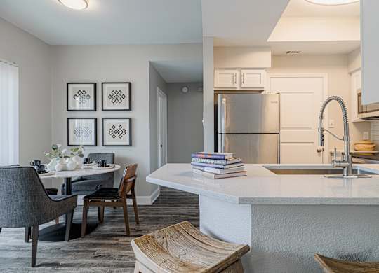 a kitchen and dining room with a sink and a refrigerator