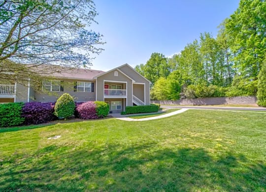 a house with a yard and a sidewalk in front of it