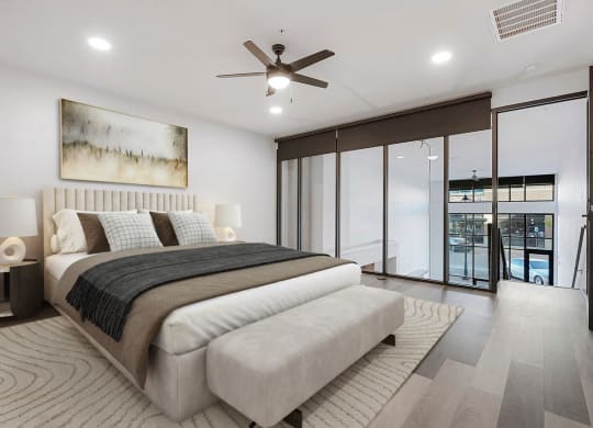 a white bedroom with a large bed and a ceiling fan
