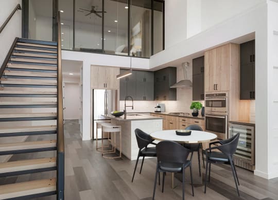 a kitchen and dining area with a white table and chairs