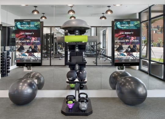 a robot in a gym with weights and other exercise equipment