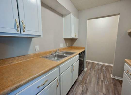 A kitchen with light blue cabinets and a brown counter top.
