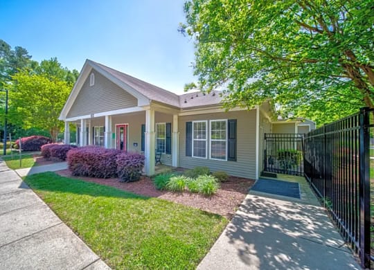 a small house with a yard and a sidewalk