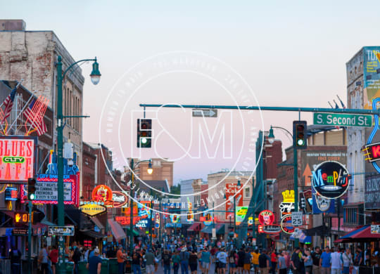 a crowd of people walking down a busy city street