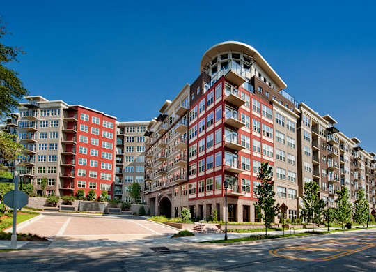 A large red and beige apartment building with a curved top.