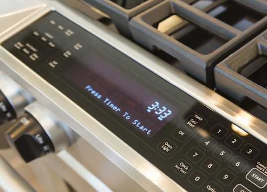 A digital display on a stove shows the time as 3:33.