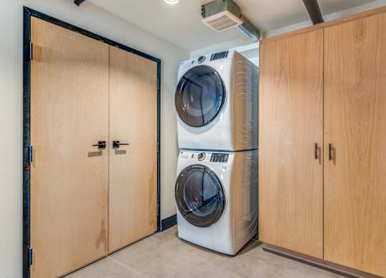 A washing machine and dryer in a laundry room.