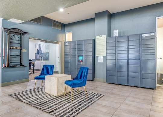 A room with blue chairs and a white table.