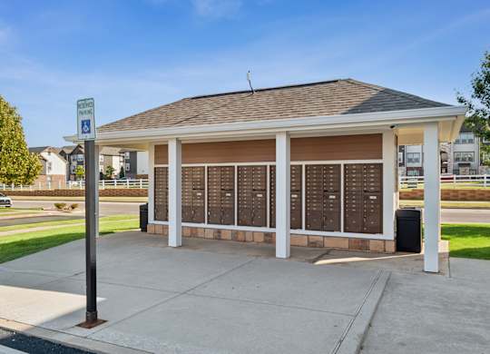 A covered waiting area with a sign for disabled parking.