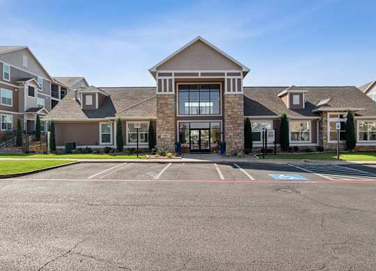 A large building with a parking lot in front of it.
