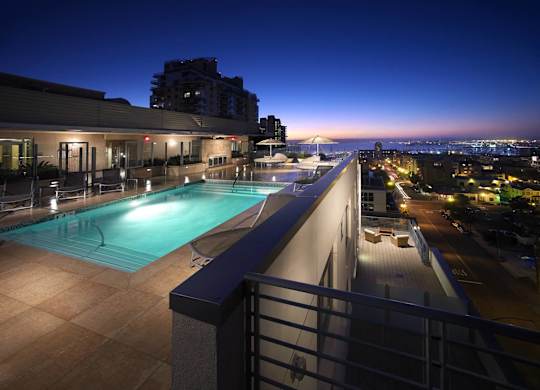 a view of a pool and a city at night