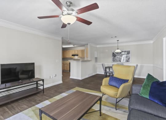 a living room with a couch and a ceiling fan