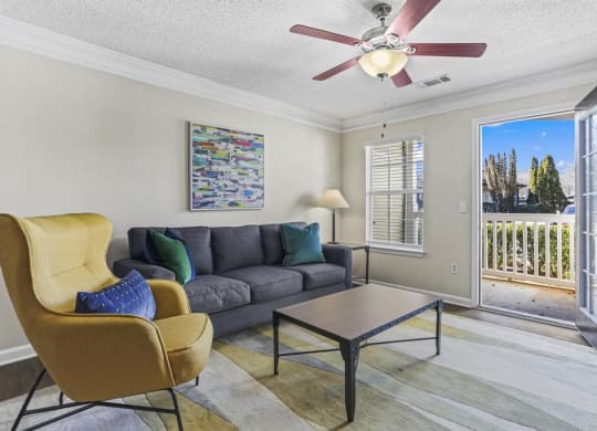 a living room with a couch and a ceiling fan