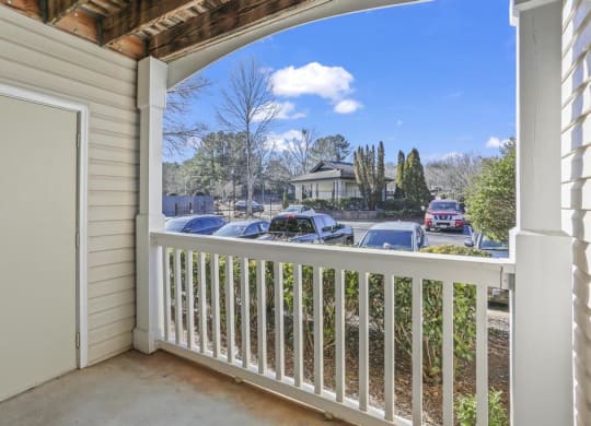 a balcony with a view of a parking lot