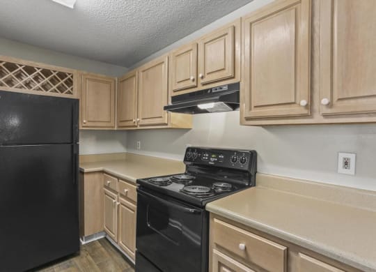 a kitchen with wood cabinets and black appliances