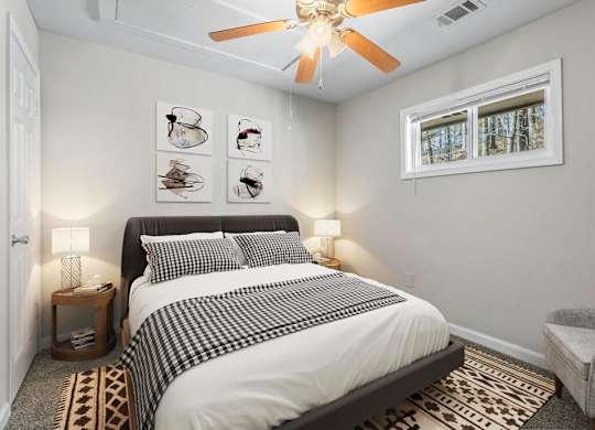 a bedroom with a bed and a ceiling fan