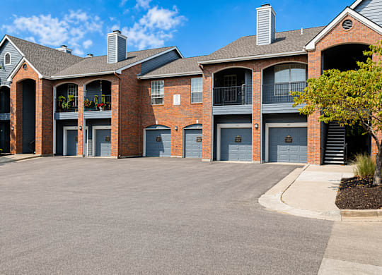 A large brick building with multiple garage doors.