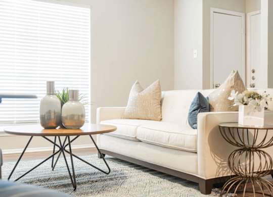 a living room with a couch and tables