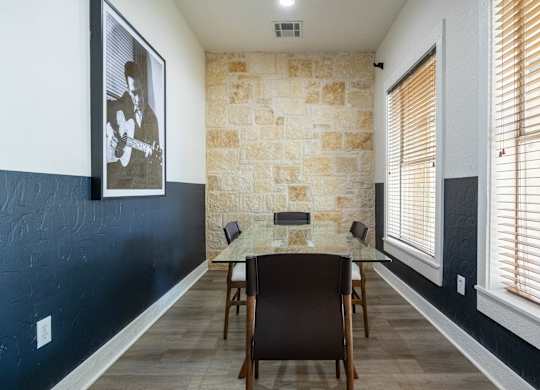 A dining room with a table and chairs.