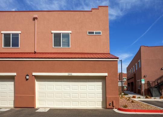 A red building with a white garage door in front.