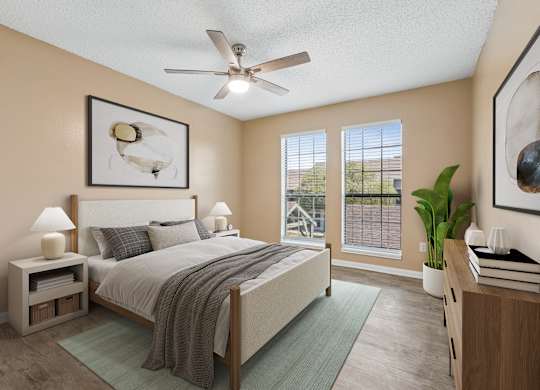 A bedroom with a bed, nightstands, and a ceiling fan.