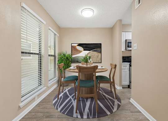 A dining room with a table set for two.