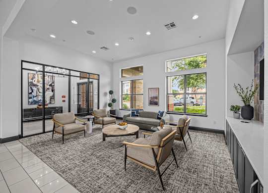 A spacious waiting room with a grey carpet and wooden furniture.