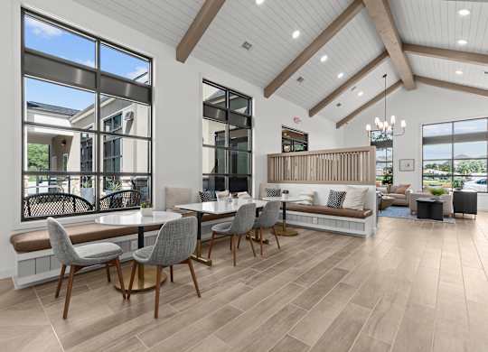 A modern dining room with a large table and chairs.