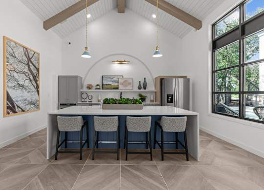 A kitchen with a table and chairs and a painting on the wall.