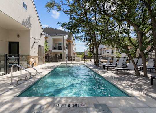 A pool with a 4 feet no diving sign in the middle.