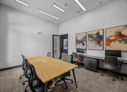 A conference room with a long table and chairs.