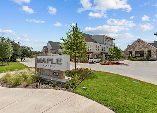 Maple Ranch sign in front of a building.