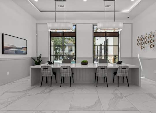 A modern dining room with a large table and chairs.