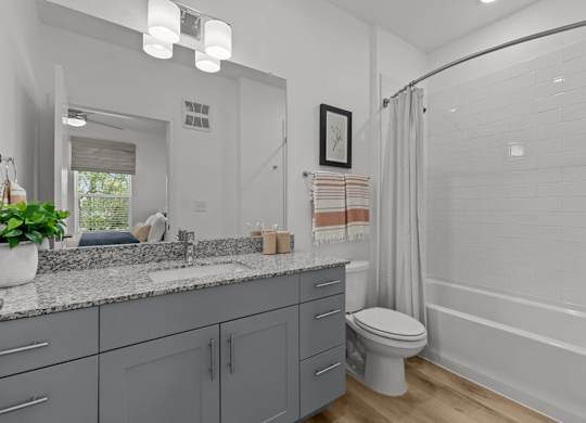 A bathroom with a toilet, sink, and bathtub.