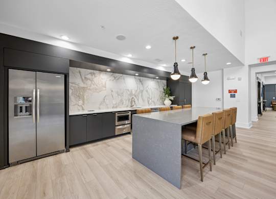 A kitchen with a marble backsplash and wooden floors.