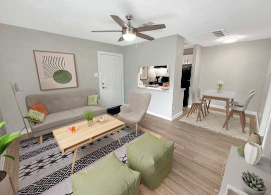 A living room with a grey couch, a wooden coffee table, and a ceiling fan.
