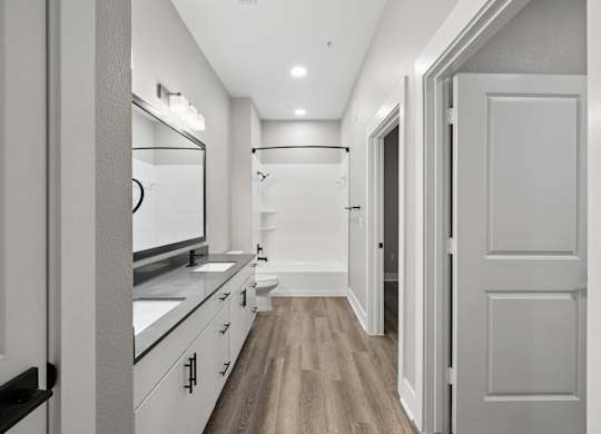 A long hallway with a white door on the right.