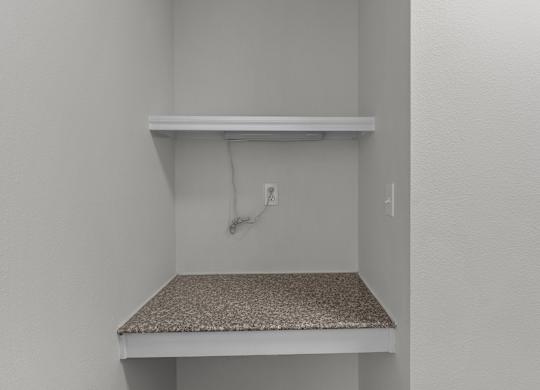the closet in a bedroom of a house with an electrical outlet